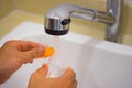 Asian father hand washing newborn milk bottle under water