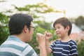 Asian father and his son making a pinkie promise