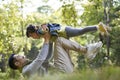 Young asian father and daughter having a good time outdoors in park Royalty Free Stock Photo