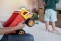 The Asian father persuaded his son to play with the car together. Selective focus