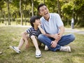 Asian father and son having a conversation