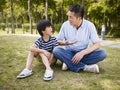 Asian father and son having a conversation Royalty Free Stock Photo