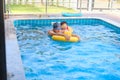 Asian Father and son having fun playing together, swimming in private swimming pool at home Royalty Free Stock Photo