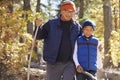 Asian father and son hiking in a forest, embracing Royalty Free Stock Photo