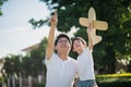 Asian father and son playing cardboard airplane together Royalty Free Stock Photo