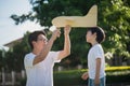 Asian father and son playing cardboard airplane together Royalty Free Stock Photo