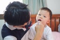 Asian Father teaching kid teeth brushing, Cute little 2 - 3 years old toddler boy child learn to brushing teeth in the morning in