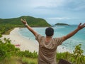 Asian fatty backpacker stand on view point on top of the island with idyllice beach ocean and blue sky in vacation time