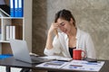 Asian female accountant suffers from eye strain that stares