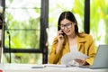 Asian female accountant talking on the phone She is a salesperson at a startup company. Royalty Free Stock Photo