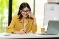 Asian female accountant talking on the phone She is a salesperson at a startup company. Royalty Free Stock Photo