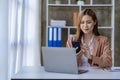 Asian female accountant talking on the phone She is a salesperson at a startup company. Royalty Free Stock Photo