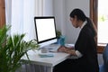 Asian female accountant working with computer at office. Royalty Free Stock Photo