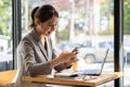 Asian female accountant working on paperwork at office while talking on the phone Royalty Free Stock Photo