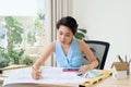 Asian female architect studying plans in office Royalty Free Stock Photo