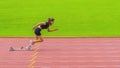 Asian female athlete accelerates during her speed running practice on the stadium track, embodying determination Royalty Free Stock Photo