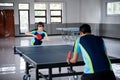 Asian female athlete preparing to serve against male athlete Royalty Free Stock Photo