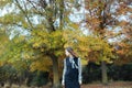 Asian female in autumn nature with black dressing Royalty Free Stock Photo