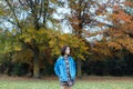 Asian female in autumn nature wearing jeans jacket Royalty Free Stock Photo