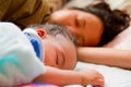 Asian female baby sleeping with her mother