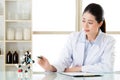 Asian female chemist teacher point at molecular model explain Sc Royalty Free Stock Photo