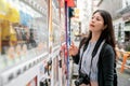 Asian female choosing what to drink.