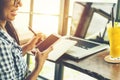 Asian female at coffee shop using laptop computer Royalty Free Stock Photo