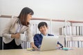 An Asian female coworker stood talking to a businessman on the desk in her hand holding a cup of coffee Royalty Free Stock Photo