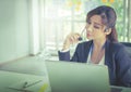 Female customer service is answering call on headphone in an operator service office Royalty Free Stock Photo