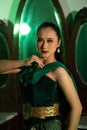 an Asian female dancer with a green dance costume and a sexy body posing very agilely while dancing Royalty Free Stock Photo