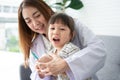 Asian female dentist teaching cute little girl brushing teeth with toothbrush and stomatologist telling girl child about oral