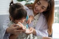 Asian female dentist teaching cute little girl brushing teeth with toothbrush and stomatologist telling girl child about oral