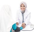Asian female doctor checking blood pressure of a patient looking Royalty Free Stock Photo