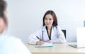 Asian female doctor is explaining diagnosis to her female patient Royalty Free Stock Photo