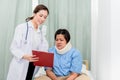 Doctor Explaining treatment procedures And health insurance plans For fat women with neck injury Royalty Free Stock Photo