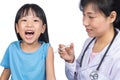 Asian female doctor giving a Chinese little girl injection Royalty Free Stock Photo