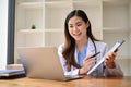 An Asian female doctor having an online medical webinar with her team Royalty Free Stock Photo
