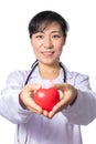 Asian female doctor holding red heart with stethoscope Royalty Free Stock Photo