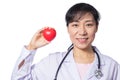 Asian female doctor holding red heart with stethoscope Royalty Free Stock Photo