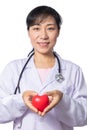 Asian female doctor holding red heart with stethoscope Royalty Free Stock Photo