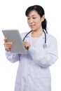 Asian female doctor holding a tablet Royalty Free Stock Photo