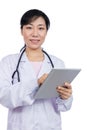 Asian female doctor holding a tablet Royalty Free Stock Photo