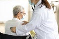 Asian Female doctor listening to sounds from the heart and lungs of senior woman at the back of the body with a stethoscope,health Royalty Free Stock Photo