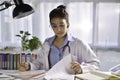 Asian female doctor looking at camera in medical office, having online consultation with patient. Young female doctor Royalty Free Stock Photo