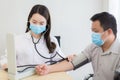 Asian female doctor measure blood pressure