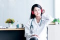 Female doctor Relaxing by listening to music from headphones While resting from the treatment Royalty Free Stock Photo