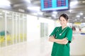 asian female doctor with stethoscope in hospital hallway