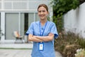 Asian female doctor with a stethoscope smile looking at camera cross arm.Nurses wear scrub smile with heartwarming comfortable.