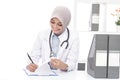 Asian female doctor with stethoscope writing down a note Royalty Free Stock Photo