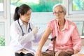 Asian female doctor with syringe doing injection vaccine,flu,influenza in the shoulder or arm of senior woman,young nurse Royalty Free Stock Photo